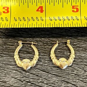 Yellow gold Claddagh earrings.